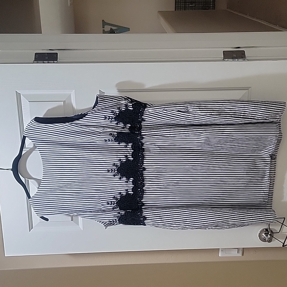 Blue and white stripped dress with dark blue lace at waste. Has Pockets
